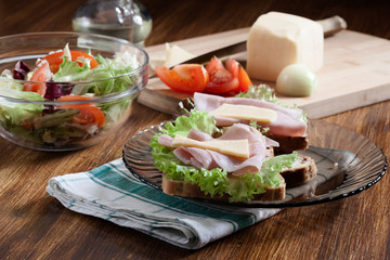 Sandwiches with cheese, ham and lettuce. Dark tone