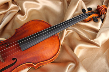 Fototapeta na wymiar Classical violin on fabric background