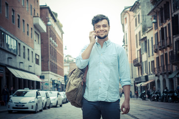 stylish man in the street at the phone