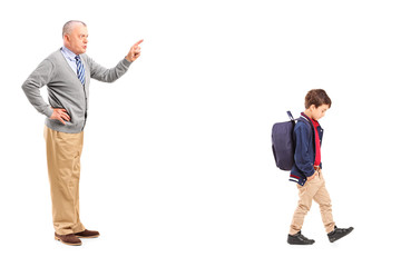 Full length portrait of a grandfather reprimanding a little boy