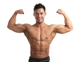 Waist-up portrait of muscular man flexing his biceps