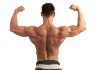 Rear view of a young man flexing his arm and back muscles