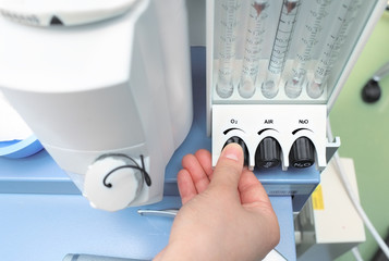 doctor adjusts the parameters of medical rotameter on the anesth