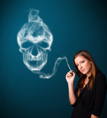 Fototapeta premium Young woman smoking dangerous cigarette with toxic skull smoke