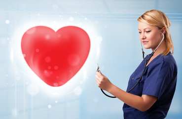Young nurse healing a red heart