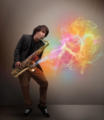 Attractive musician playing on saxophone with colorful abstract