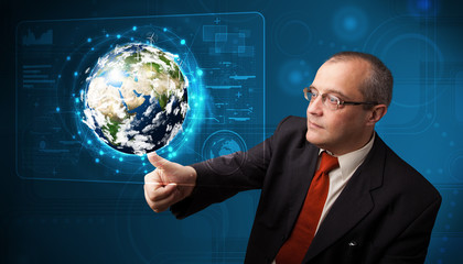Businessman touching high-tech 3d earth panel