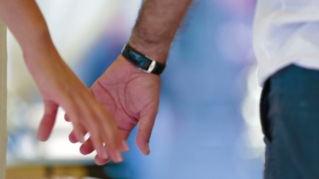 Man and woman holding hands. Close-up