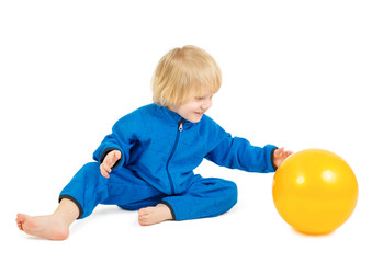 Fototapeta na wymiar Cute baby boy plays with yellow ball