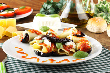 Fototapeta na wymiar Paccheri pasta with eggplant, ricotta cheese and tomato
