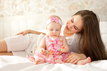 happy-looking baby and mother playing together