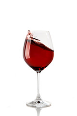 Splash of red wine in a glass