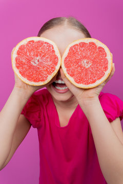 Grapefruit - a young girl with grapefruits - diet concept