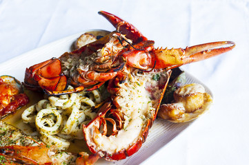 Grilled red Lobster on platter.