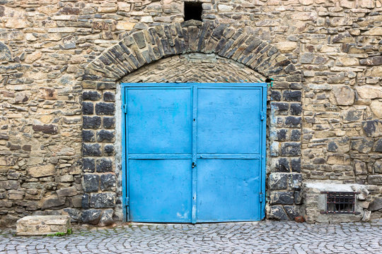 stone wall with blue door