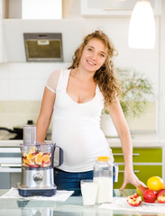 pregnant woman with healthy food in kitchen 