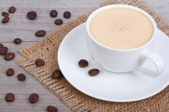 coffee with foam on a napkin from a sacking