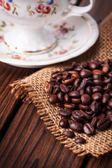 coffee beans with sugar cubes on wooden background