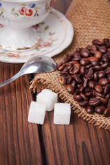 coffee beans with sugar cubes on wooden background
