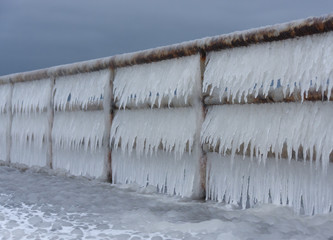 Handrail full of hanging icicles