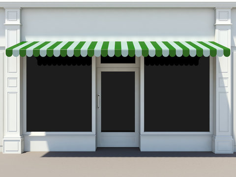 Shopfront in the sun - classic store front with green awnings