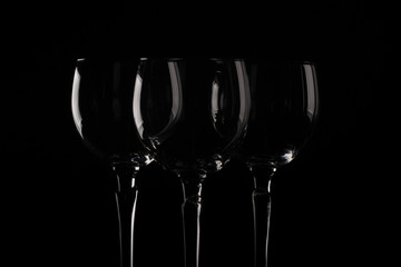Glasses of alcohol drinks on black gackground