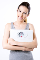 Closeup of cheerful fitness woman with scales
