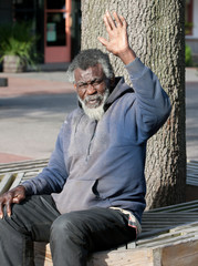 Fototapeta premium Poor elderly Homeless man waving