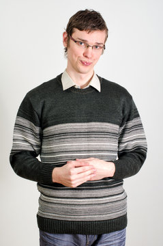 Portrait of young shy guy in glasses