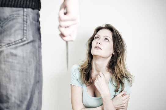 Man with knife coming to his wife. Home violence concept