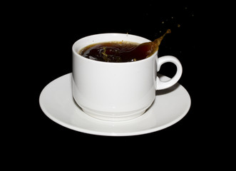Sugar cube dropped into a cup of coffee