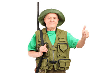 Fototapeta premium A male hunter with shotgun giving a thumb up