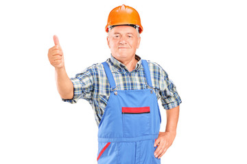 A male worker with helmet giving a thumb up
