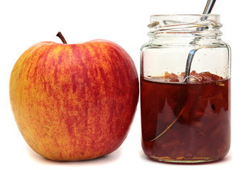 Apples and glass jar with jam isolated on white background.