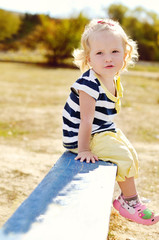 Fototapeta premium toddler sitting on the bench