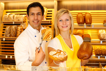 Baker and shopkeeper present pastry