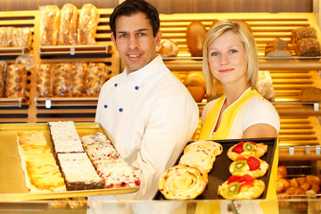 Baker and shopkeeper present pastry