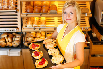 Bakery shopkeeper with cake or pastry
