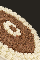 Chocolate shavings and cream on a brown background
