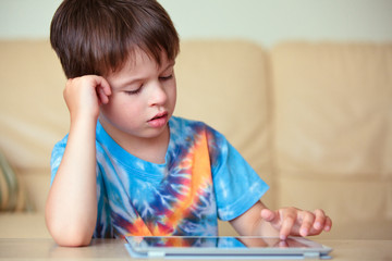 Cute little boy with a tablet pc