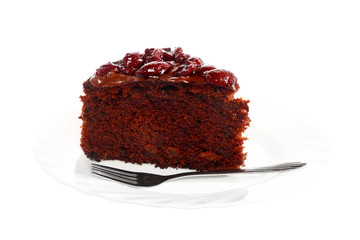 Piece of chocolate cake with icing and cherry