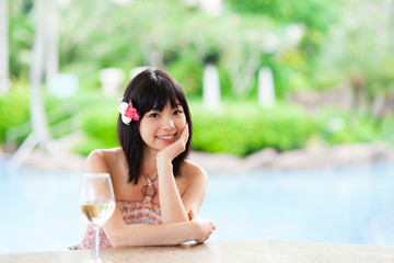 a young asian woman relaxing in the resort hotel