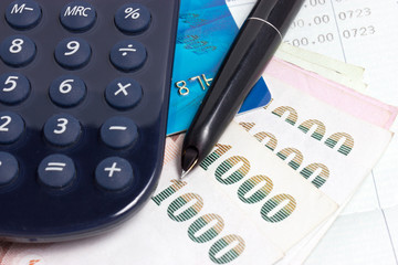 Credit card, Thai bank notes and calculator with bankbook.