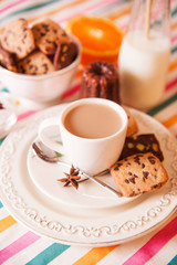 chocolate cookie and cup of coffee with milk and cinnamon