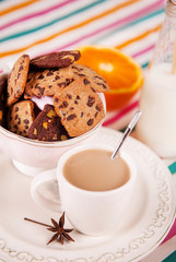 chocolate cookie and cup of coffee with milk and cinnamon