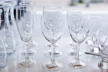 Group of empty crystal clear glasses and bottles