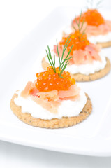 appetizer crackers with cream cheese, salmon and red caviar