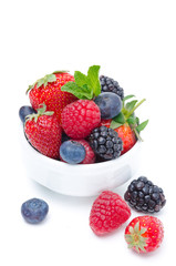 Assorted of fresh berries in a white bowl isolated on white