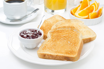 breakfast with toasts, jam, coffee and orange juice