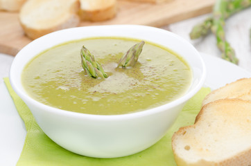 cream soup of asparagus and green peas close-up